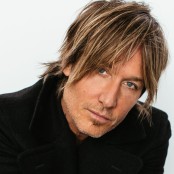 A close up image of Keith Urban wearing a black jacket